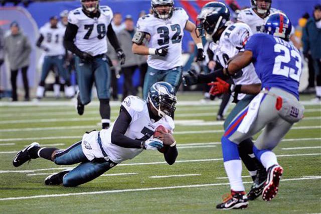 Michael Vick dives for extra yards in the 4th quarter at the Meadowlands
